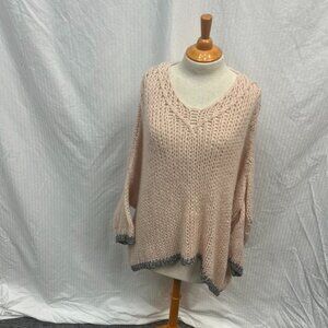oversized pink batwing sweater with silver  borders on bottom and cuffs